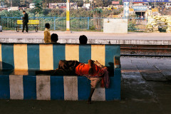 man waiting for a train in india