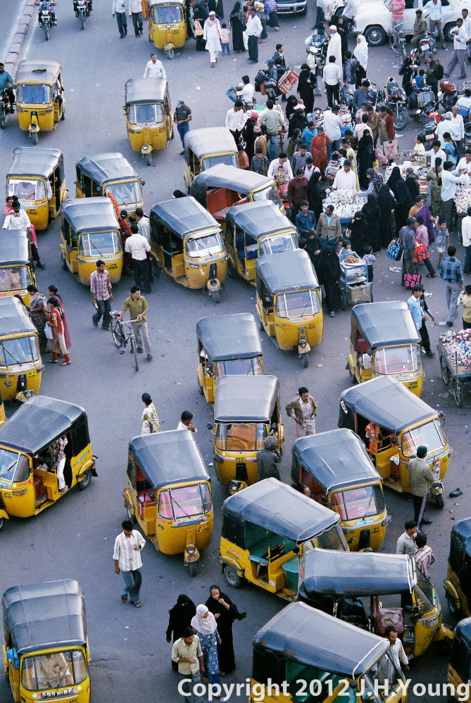 swarms of motorized rickshaws